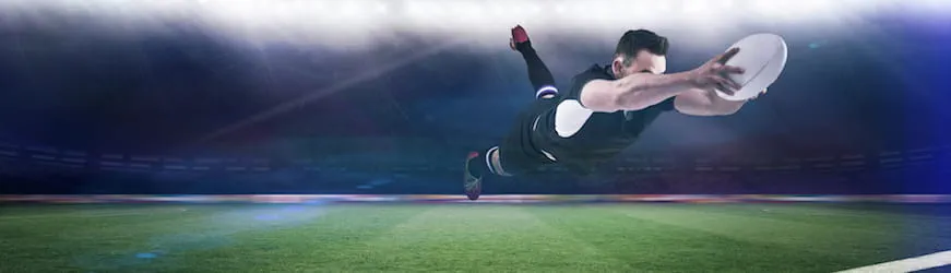 un joueur de rugby sur un terrain qui transforme un essai