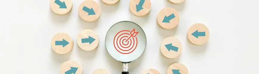 Une loupe zoome sur un pictogramme de cible : un symbole évoquant la nécessité de toujours contrôler les informations fournies par IA, même en matière de recherche d’emploi.