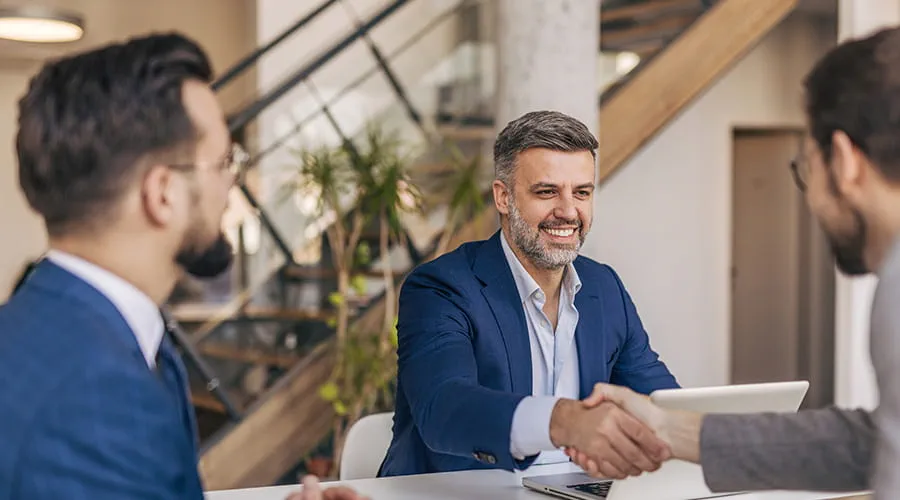 Empresarios se dan la mano después de una exitosa reunión en una oficina moderna Empresarios se dan la mano después de una exitosa reunión en una oficina moderna