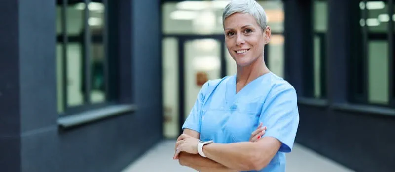 Une soignante souriante cumulant emploi et retraite Une soignante souriante cumulant emploi et retraite