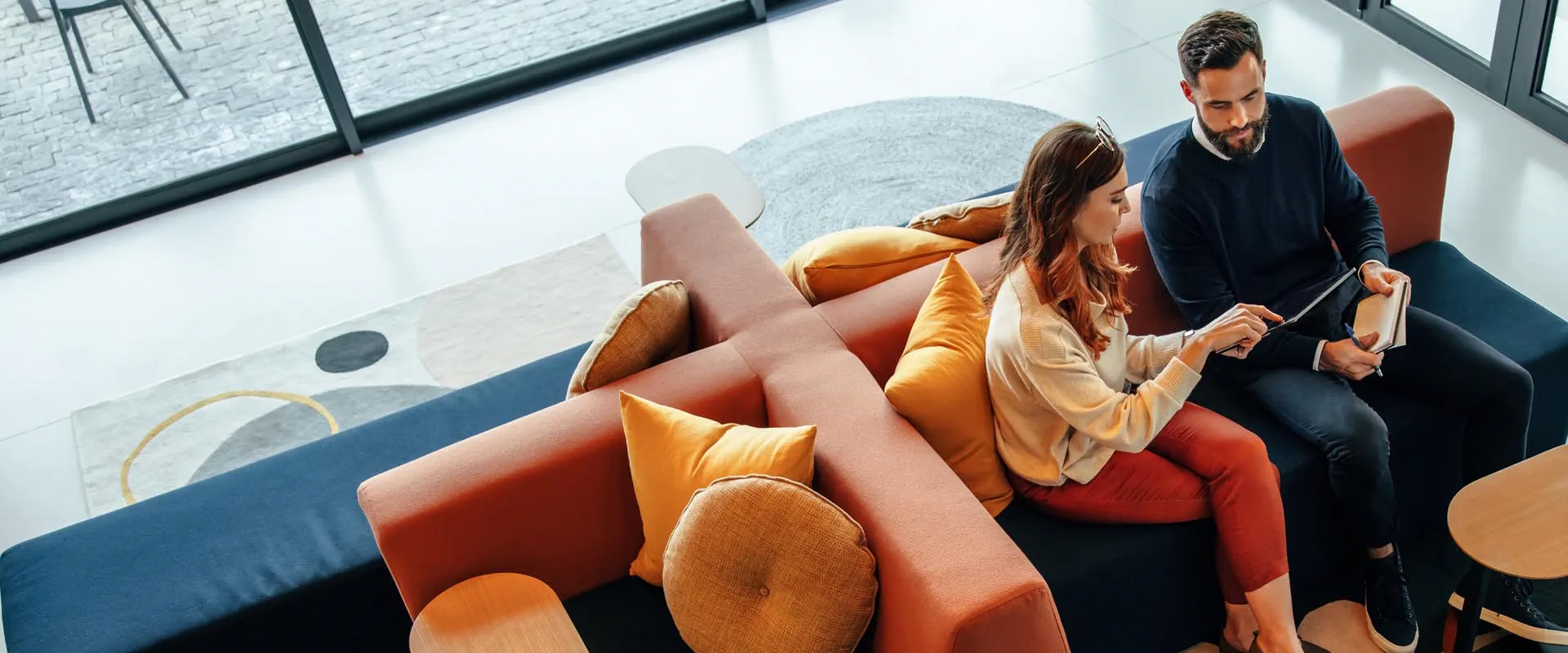 Business team preparing for a meeting in a modern lounge area Business team preparing for a meeting in a modern lounge area