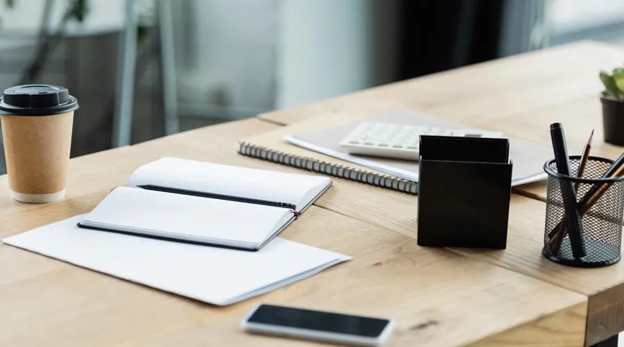 Clean and organised desk setup with a laptop and stationery Clean and organised desk setup with a laptop and stationery