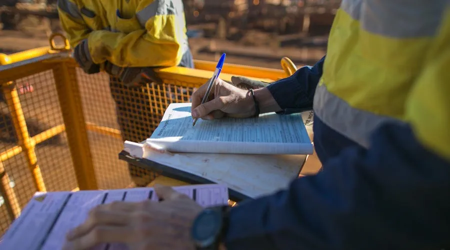 Mining worker completing paperwork on site