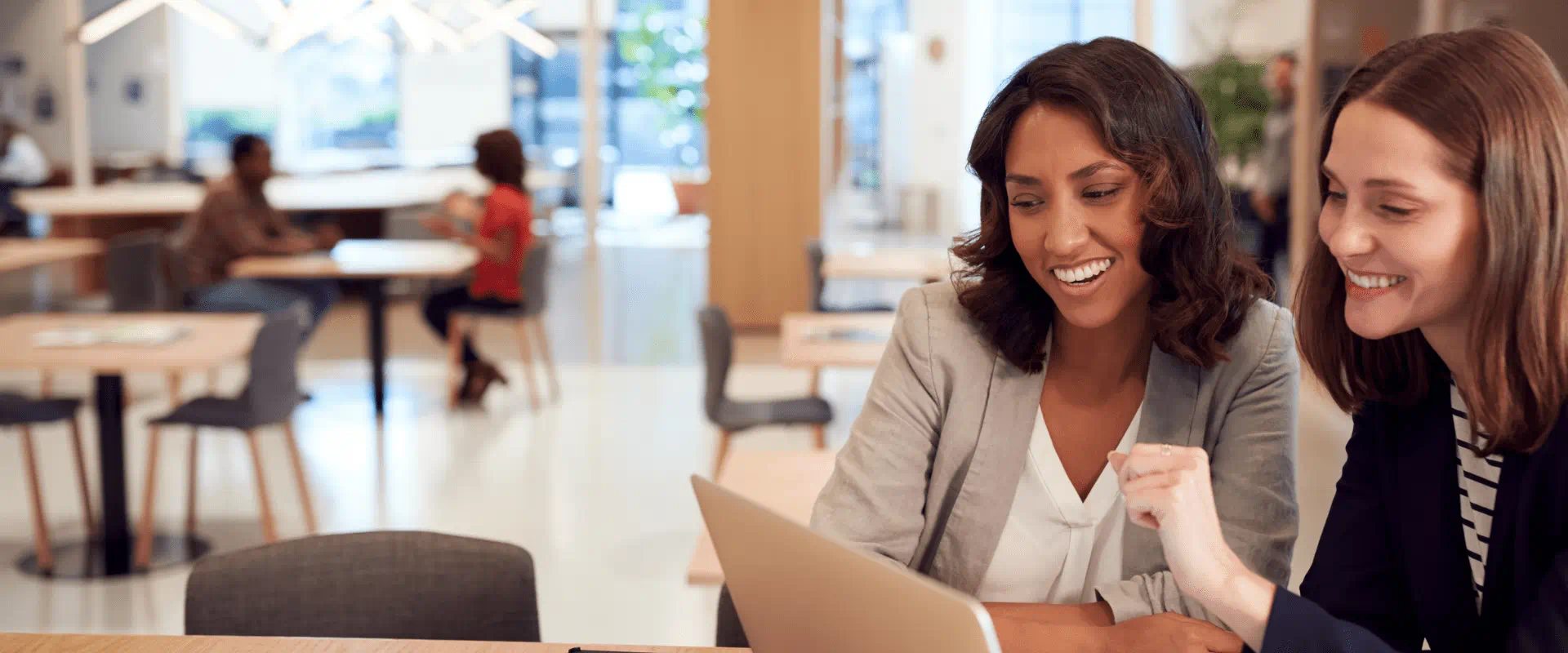 Two colleagues reviewing a tablet together in a workplace Two colleagues reviewing a tablet together in a workplace
