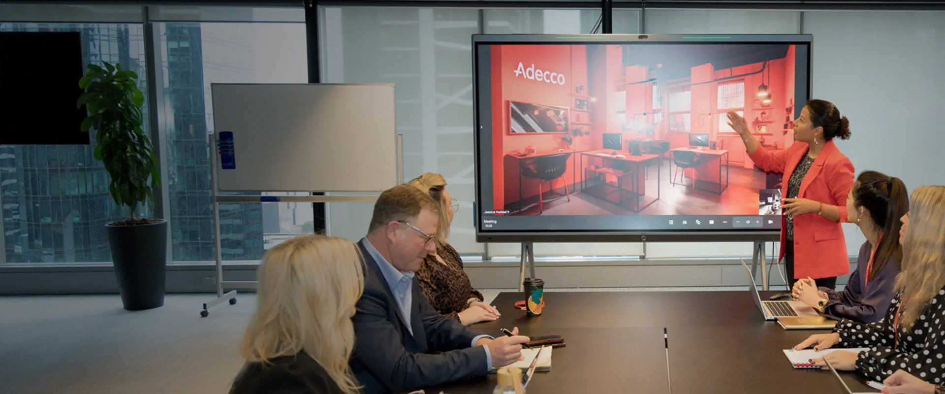 A group of staff seated around a table in a meeting room. A group of staff seated around a table in a meeting room.
