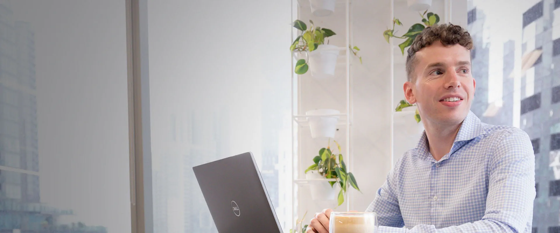 A man working on a laptop while looking to the side. A man working on a laptop while looking to the side.