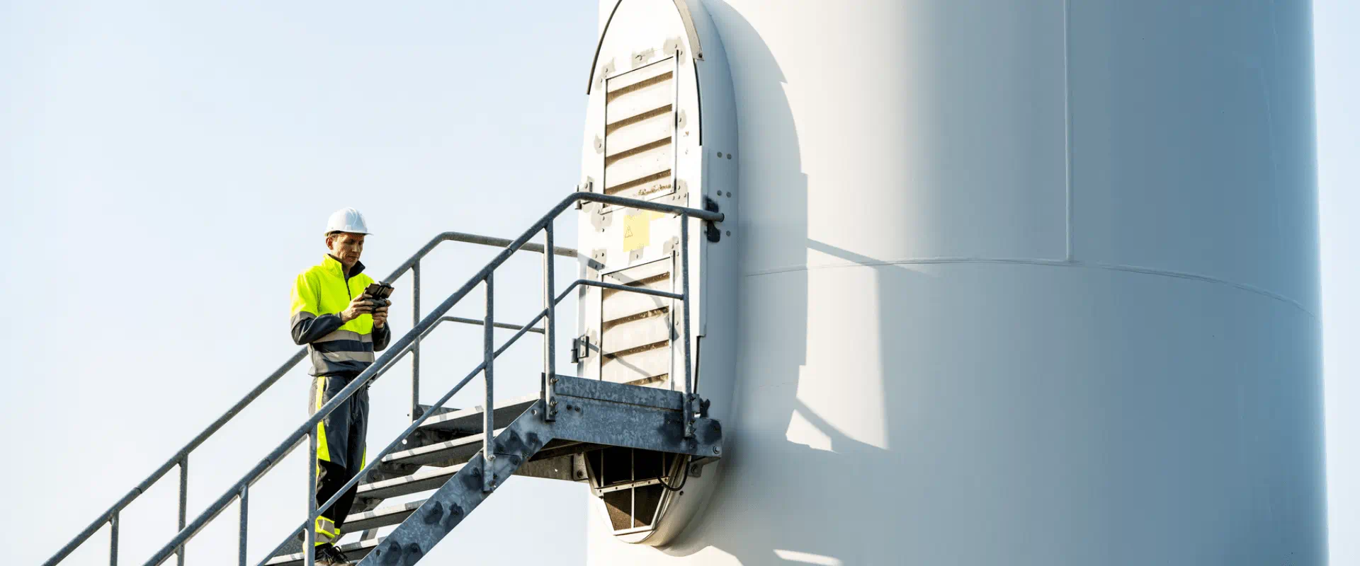Technician working on wind turbine at height Technician working on wind turbine at height