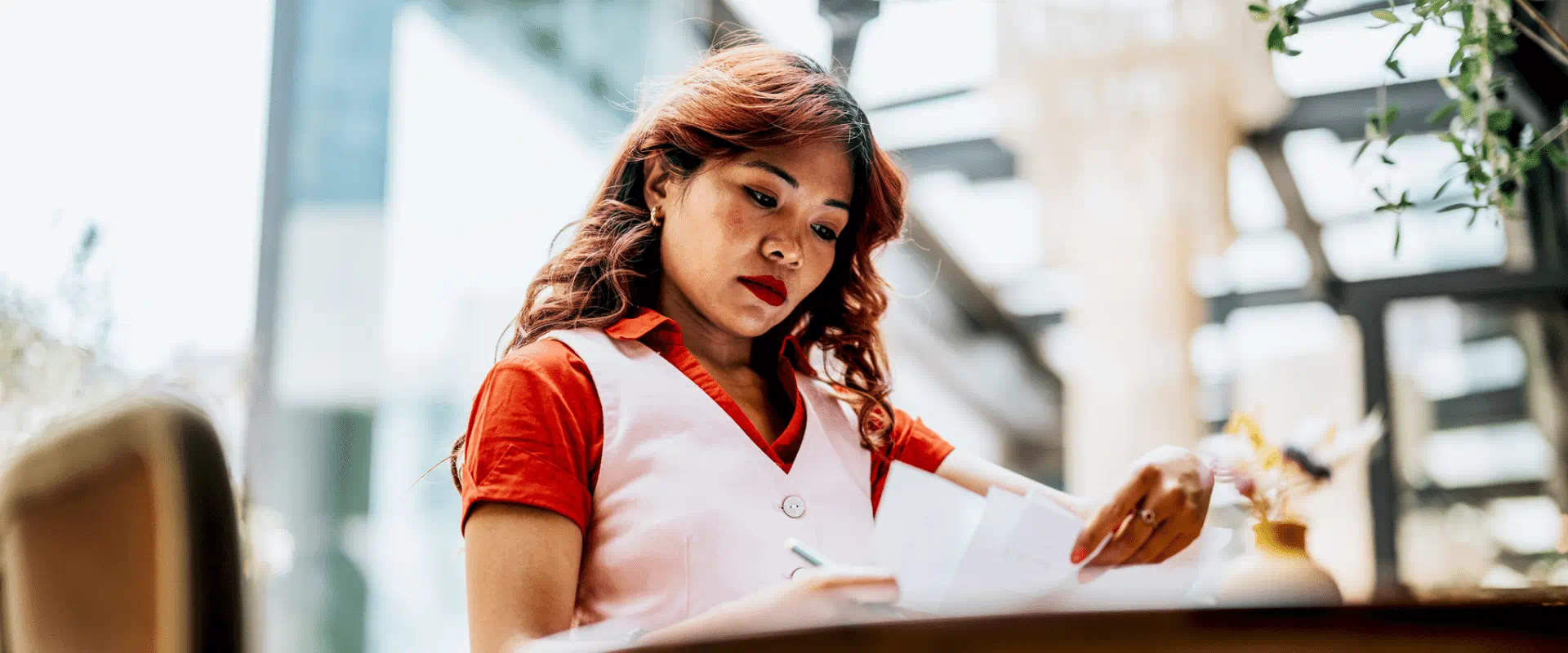Woman working at desk with papers Woman working at desk with papers