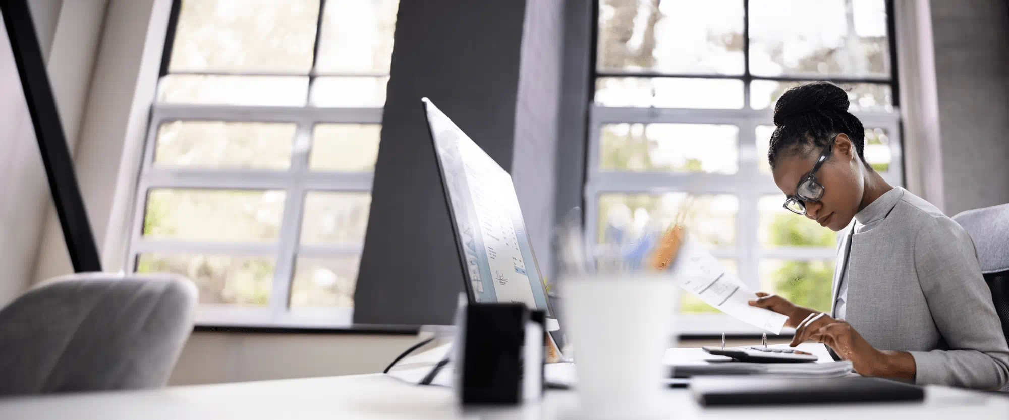 Woman in an office using a calculator