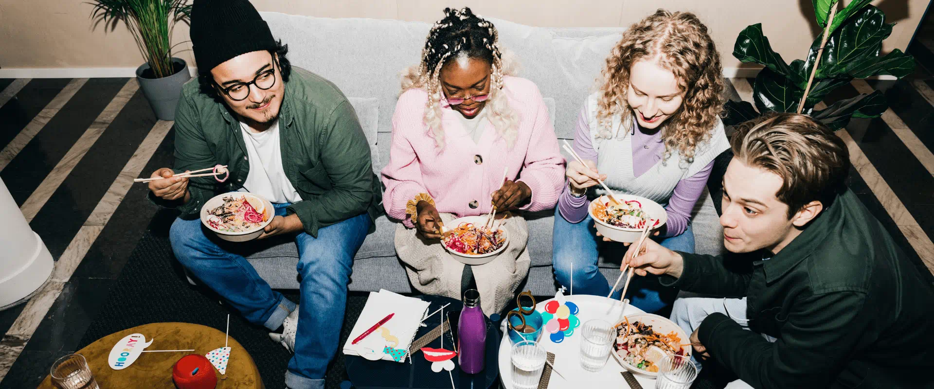 A group of colleagues sharing a meal together during an informal workplace gathering.