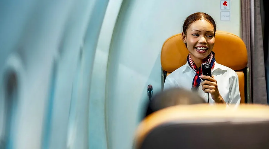 Flight attendant speaking to passengers onboard aircraft Flight attendant speaking to passengers onboard aircraft