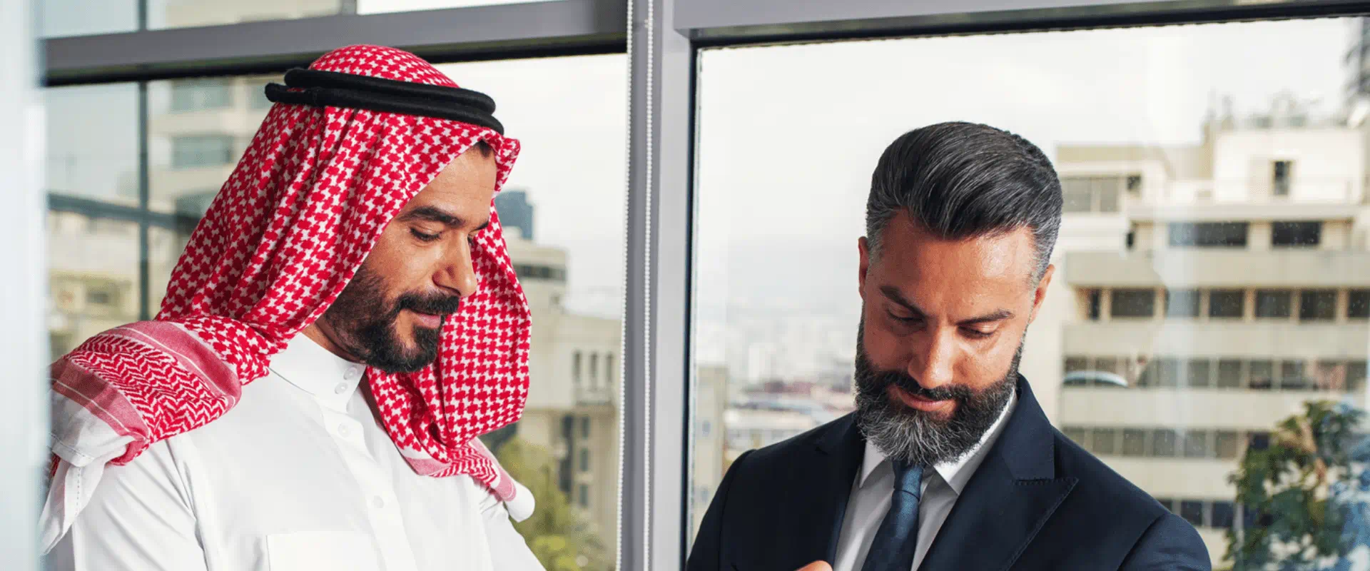 Arabian Business man with a foreign businessman discussing work in a modern office Arabian Business man with a foreign businessman discussing work in a modern office