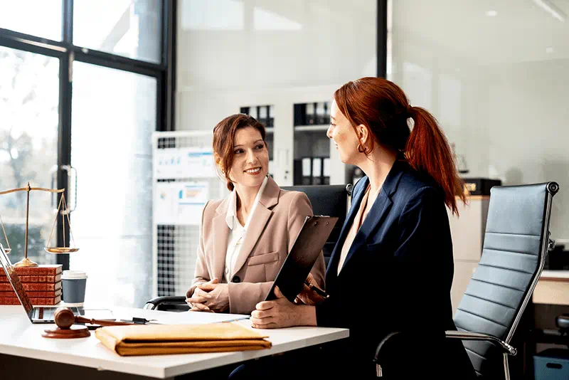 Two business professionals discussing career growth and promotion opportunities during a workplace meeting in a modern office environmen Two business professionals discussing career growth and promotion opportunities during a workplace meeting in a modern office environmen