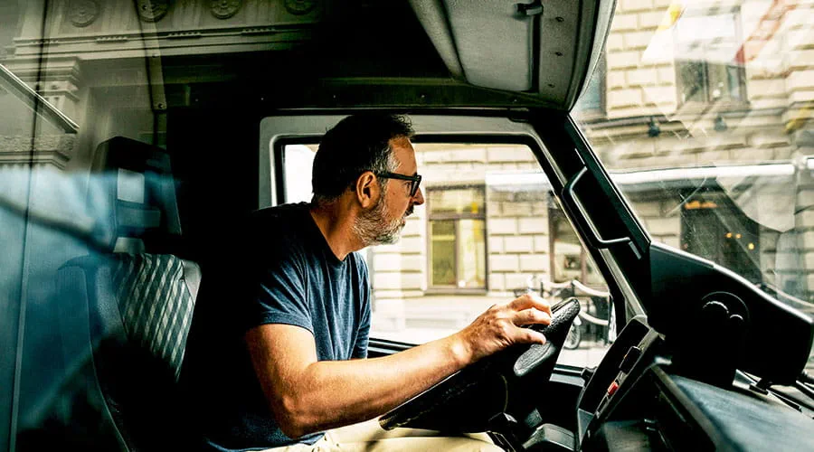 Delivery driver using mobile device inside vehicle Delivery driver using mobile device inside vehicle