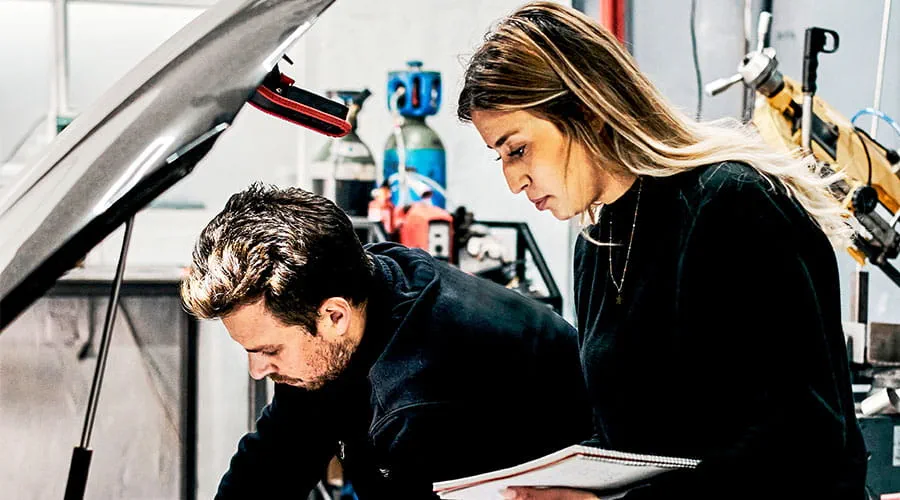Équipe examinant ensemble des plans de projets automobiles