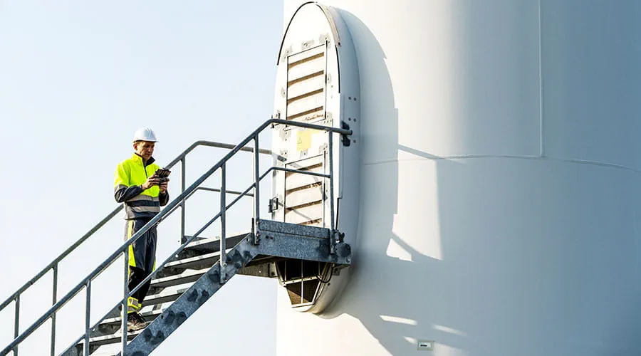 Technician working on wind turbine at height