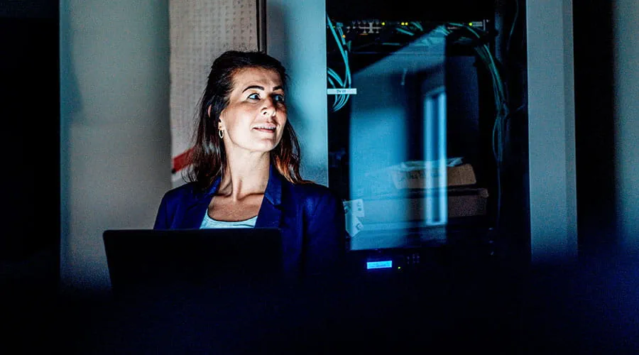 Woman working on computer in control room