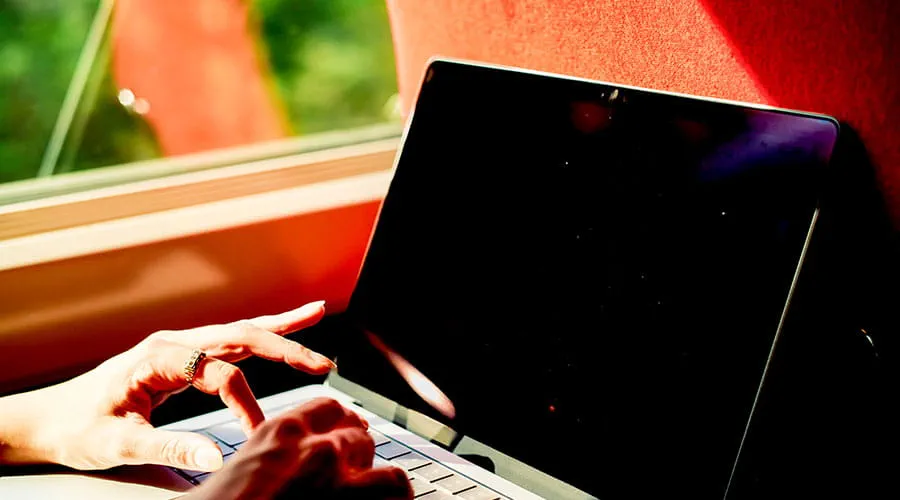 Person typing on laptop at desk Person typing on laptop at desk