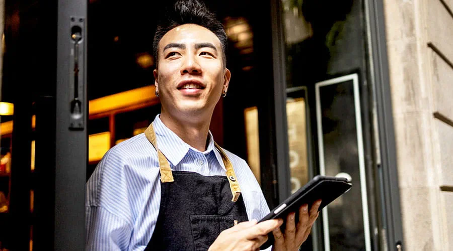 Retail worker using tablet in store Retail worker using tablet in store