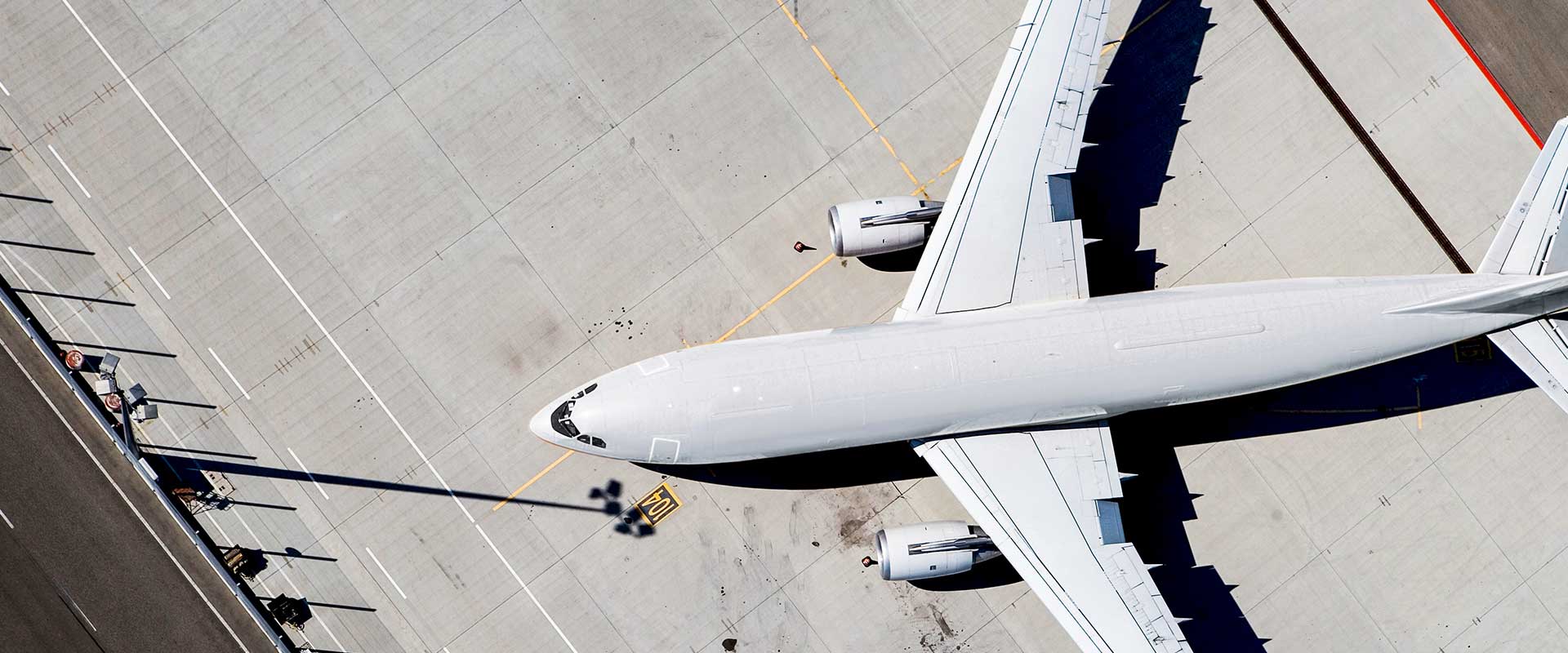 Aerial view of aircraft on airport tarmac during turnaround operations Aerial view of aircraft on airport tarmac during turnaround operations