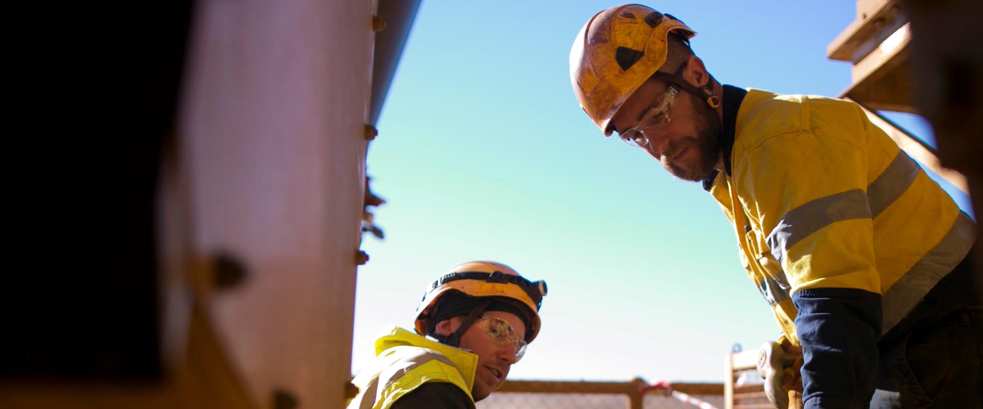 Mining riggers working on-site with safety helmets