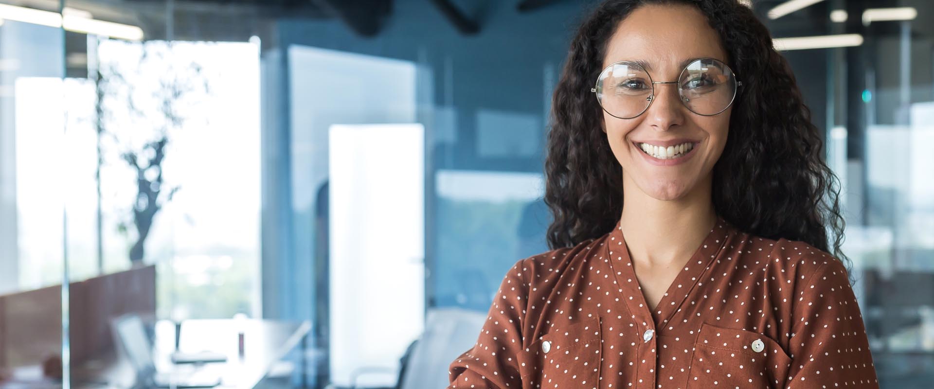 Brunette professional woman smiling in a business setting