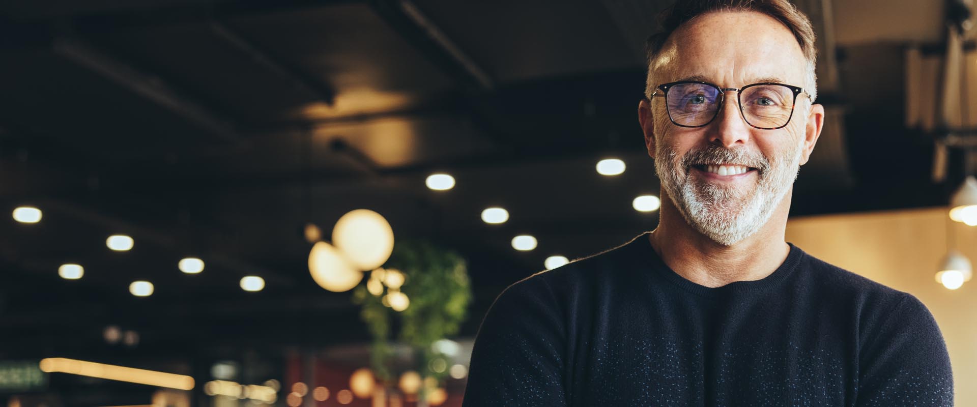Older male professional smiling confidently at work
