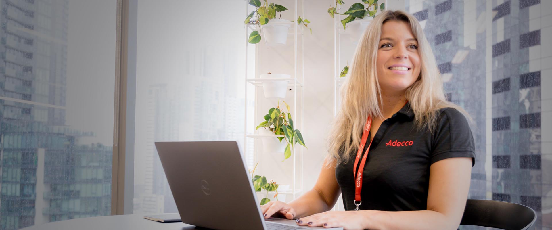 Young female office worker smiling at her desk