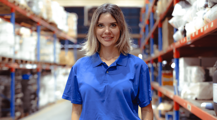 Worker standing in a warehouse aisle