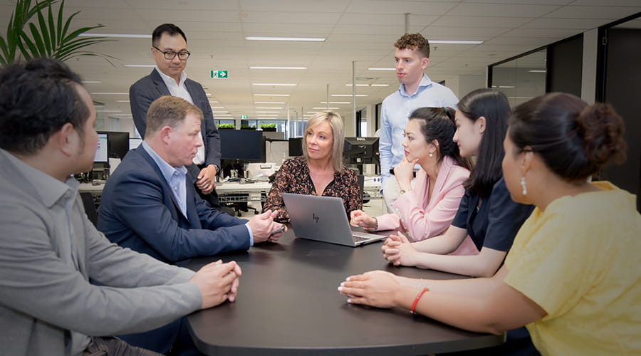 A group of colleagues in discussion. A group of colleagues in discussion.
