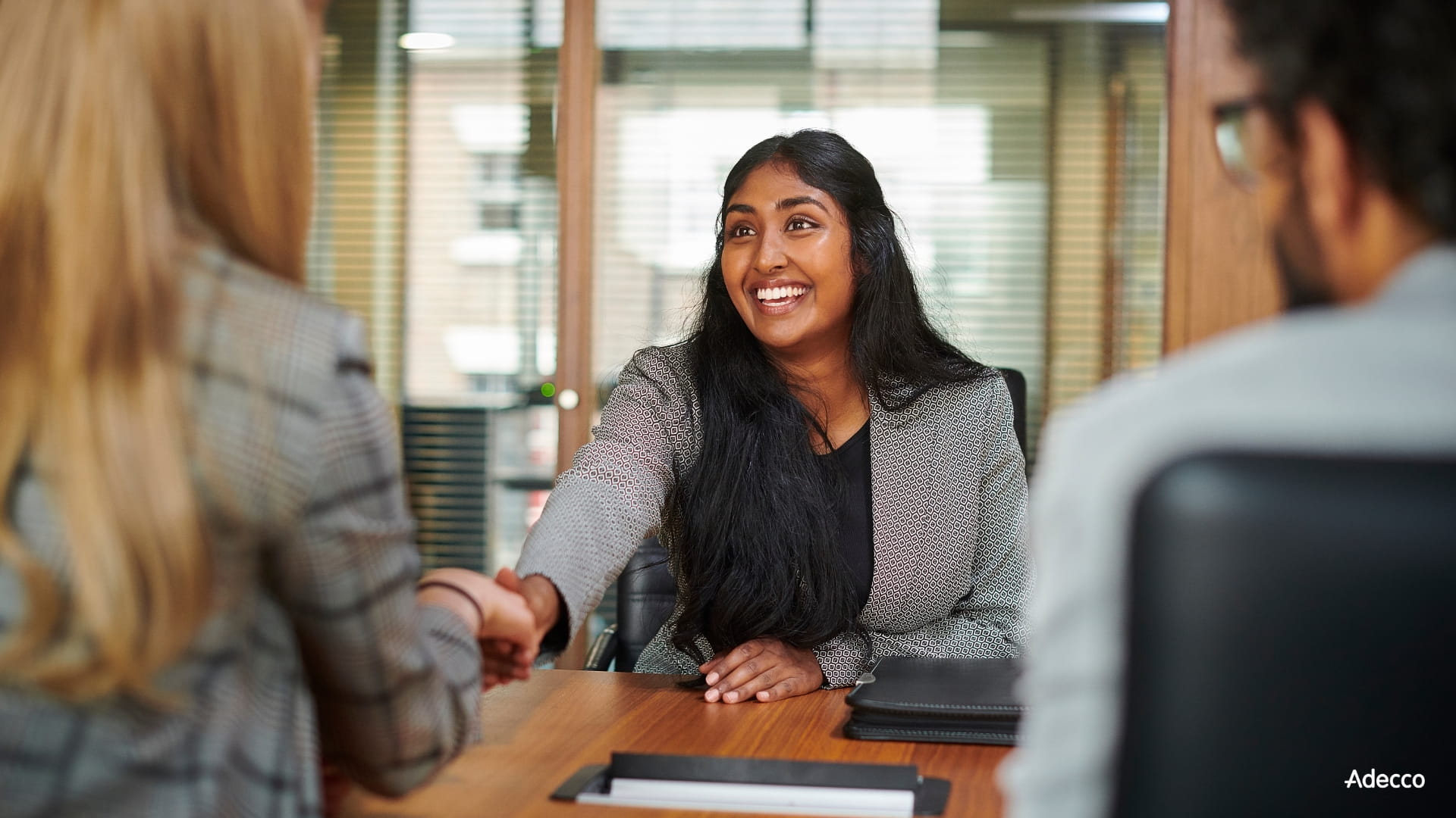 woman sitting in front of two recruiters before an interview woman sitting in front of two recruiters before an interview