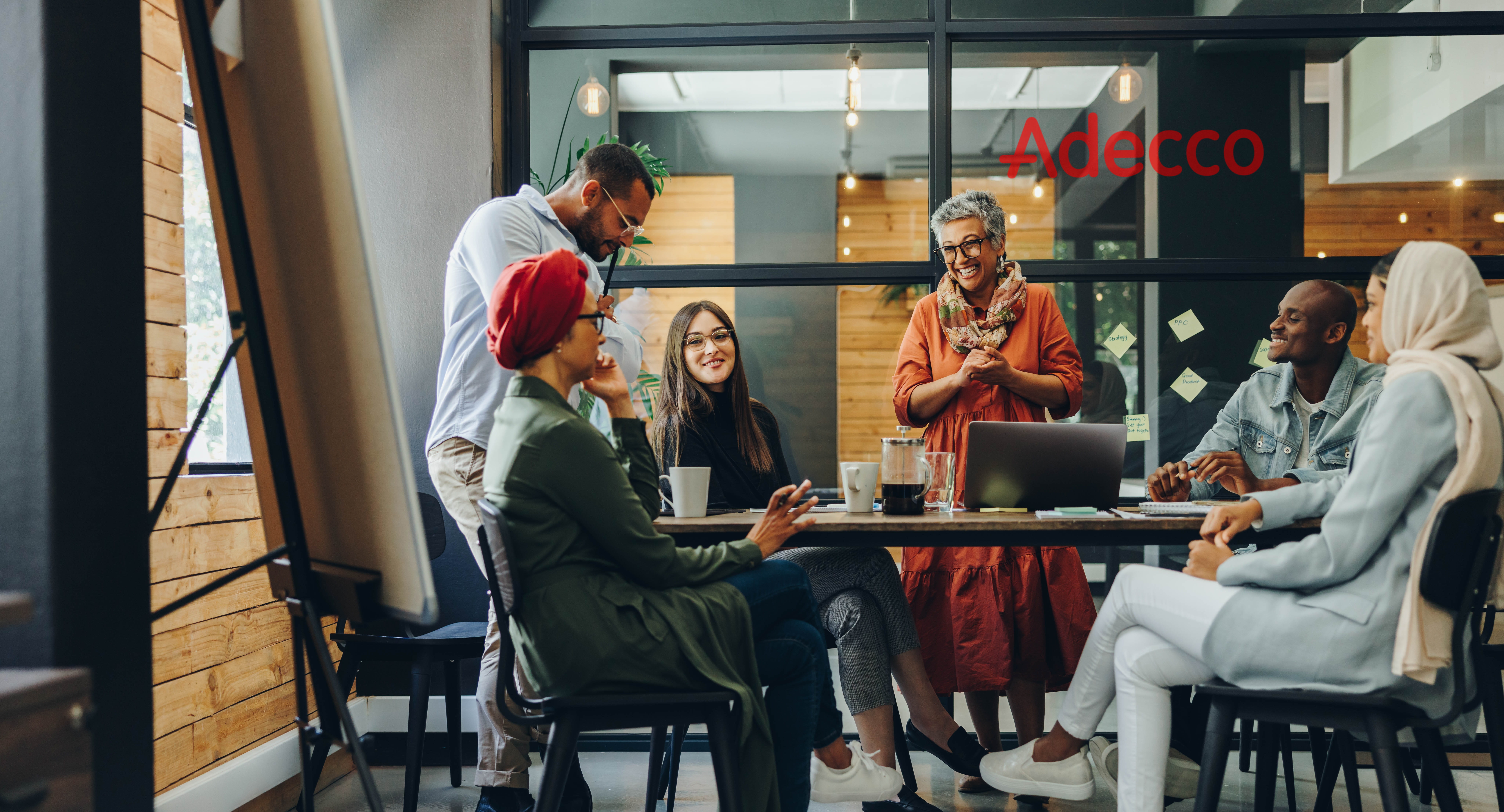 Adecco's team of talent consultants, recruiters, and workforce specialists collaborating at a branch office.