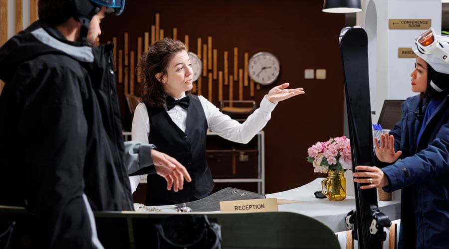 Hotel staff assisting guests at the reception area