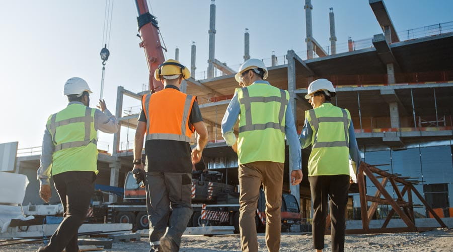 Construction workers inspecting a commercial building site