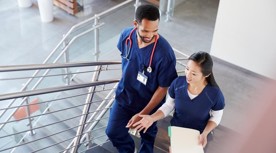 Medical professionals discussing patient care in a hospital corridor