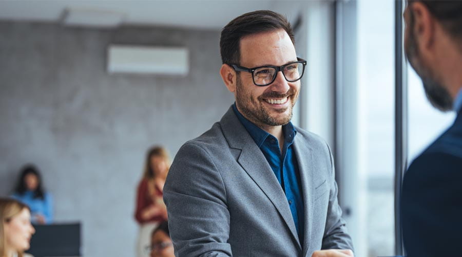 Smiling businessman shaking hands in a professional setting