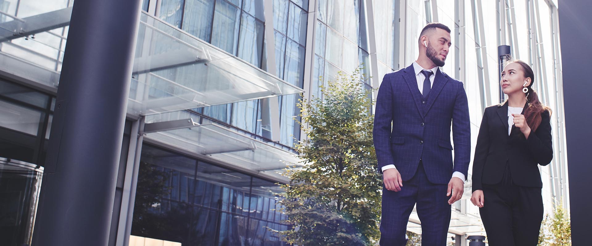 Real estate agents meeting clients outside a modern building