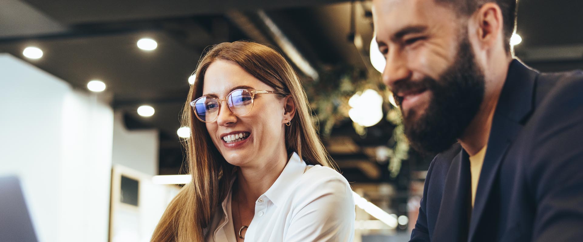 Coworkers sharing a laugh while working together