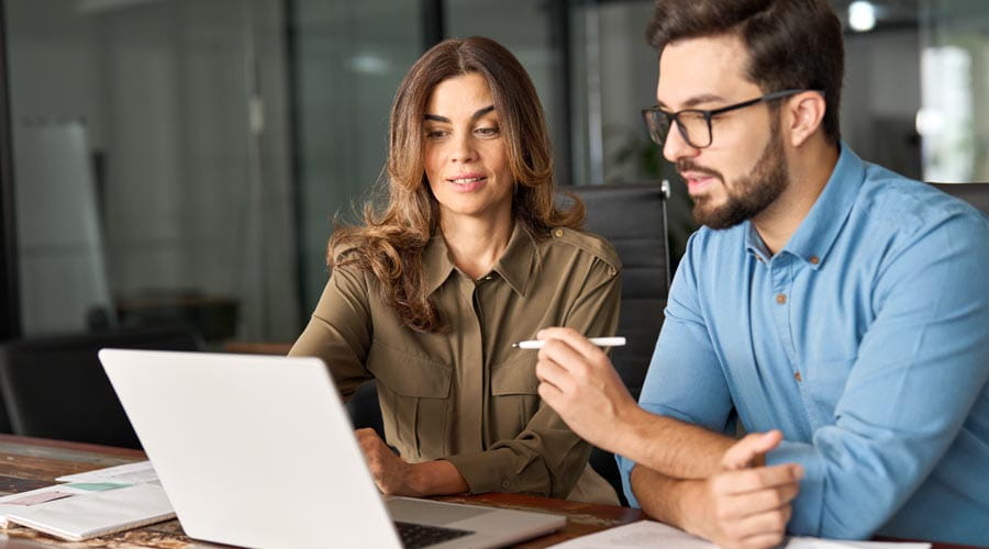 Business mentor guiding a  professional during a  collaboration session