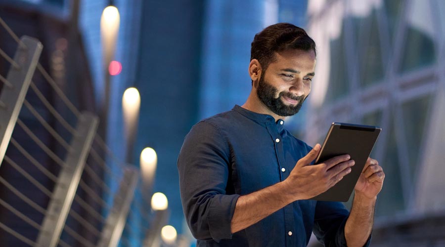 Successful businessman  using a tablet to analyse  data