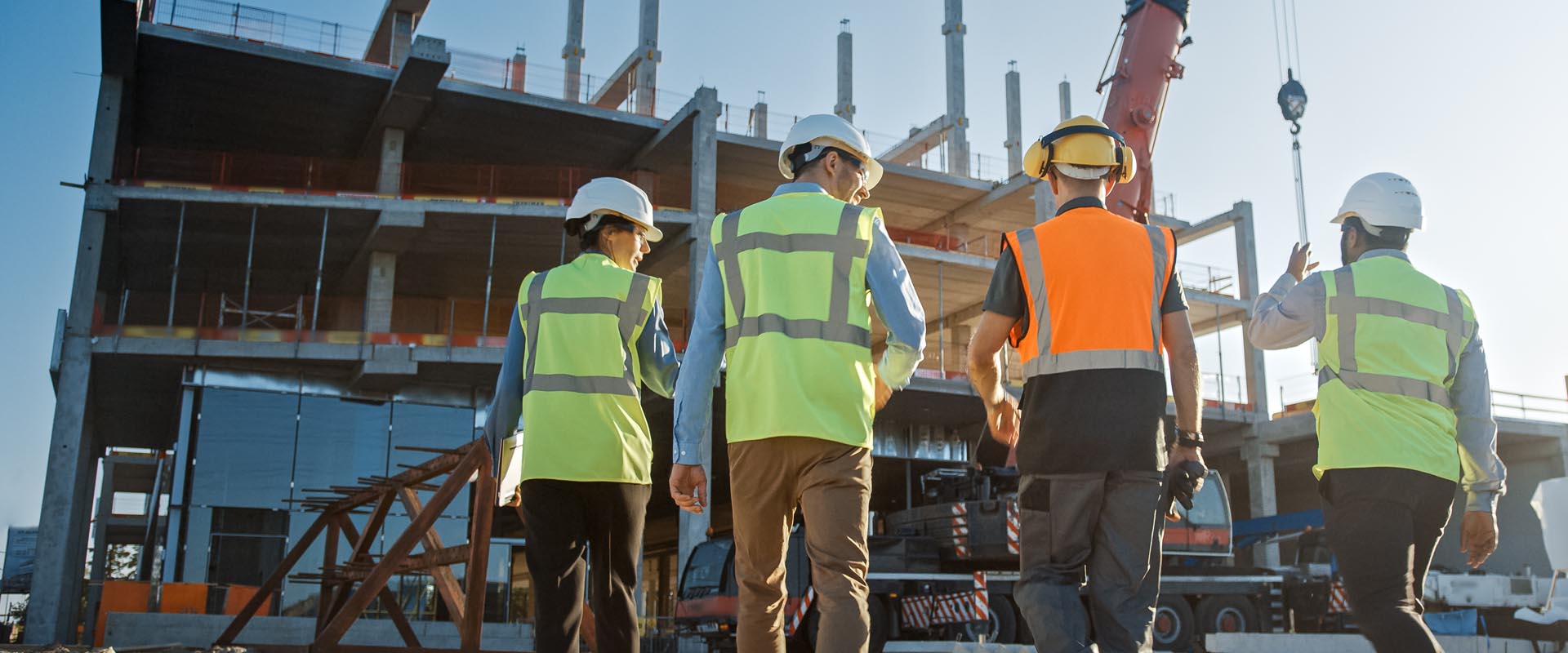 Construction project team  collaborating on-site with  safety gear