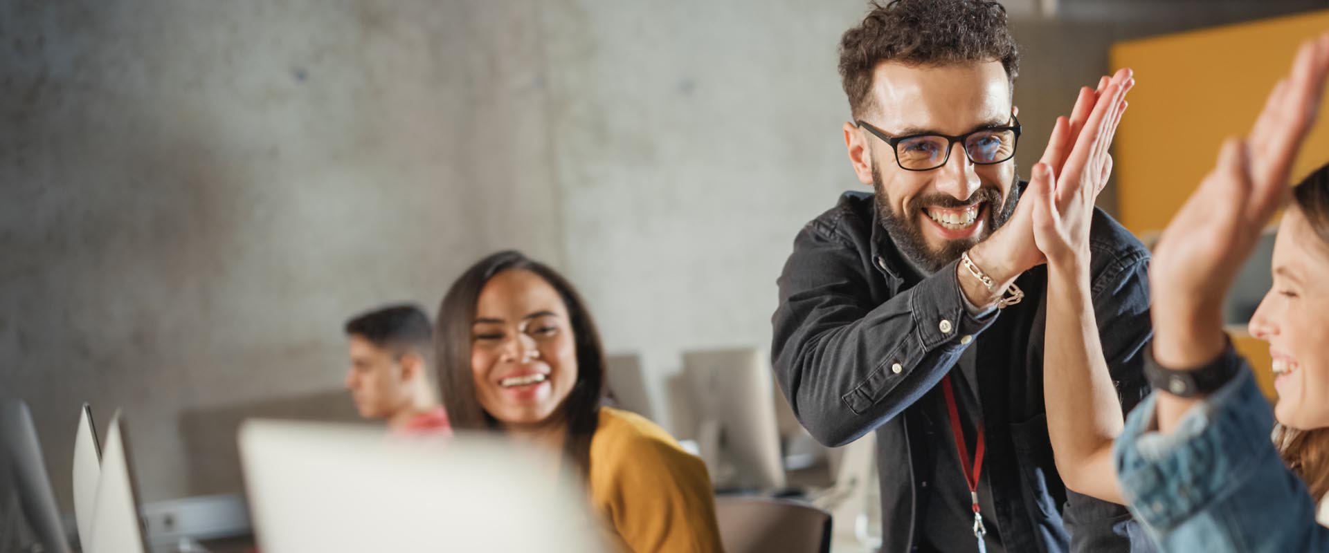 Team celebrating success  with a high-five gesture