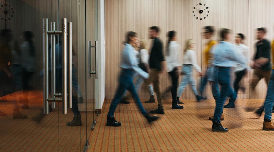 Blurred motion of people  walking through a modern  office lobb