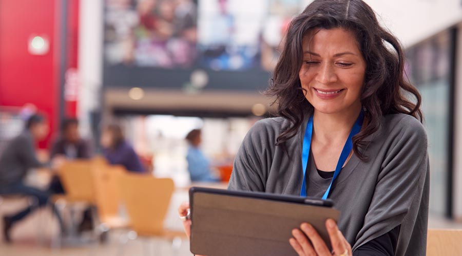 Smiling female  professional using a tablet  at her desk