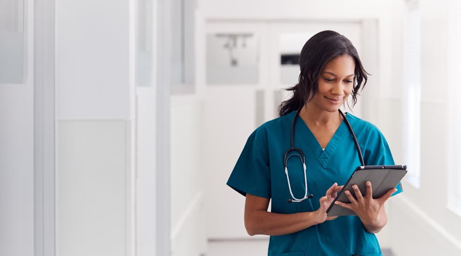 Nurse working on a tablet  in a medical environment