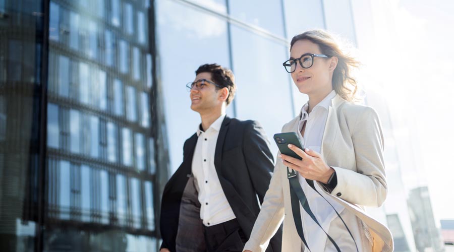 Business professionals  walking to a meeting in a  modern office  environment
