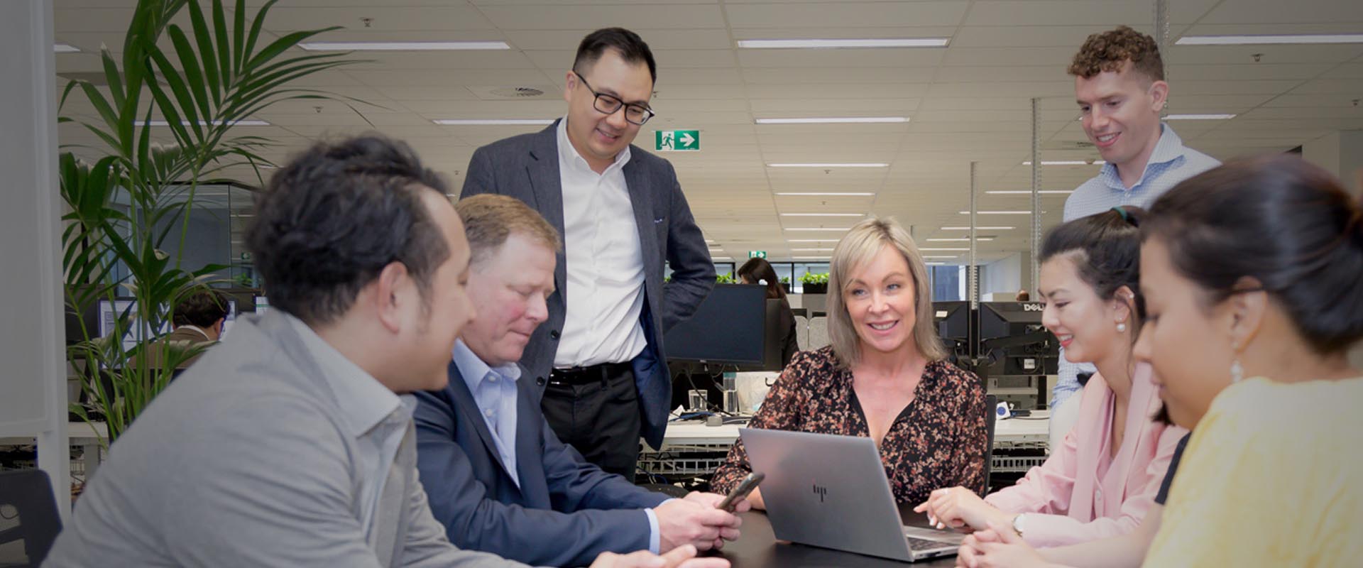 Adecco team engaged in a collaborative discussion in an office setting