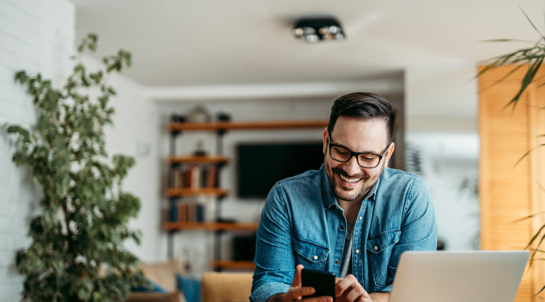 Person working from home on a laptop, representing hybrid work and its challenges like communication gaps and work-life balance.