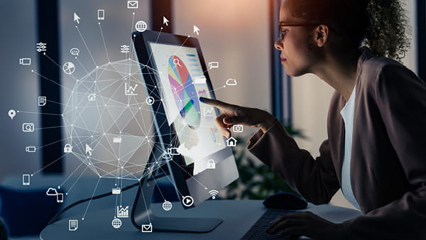 Person interacting with touchscreen displaying colorful data charts and tech icons Person interacting with touchscreen displaying colorful data charts and tech icons
