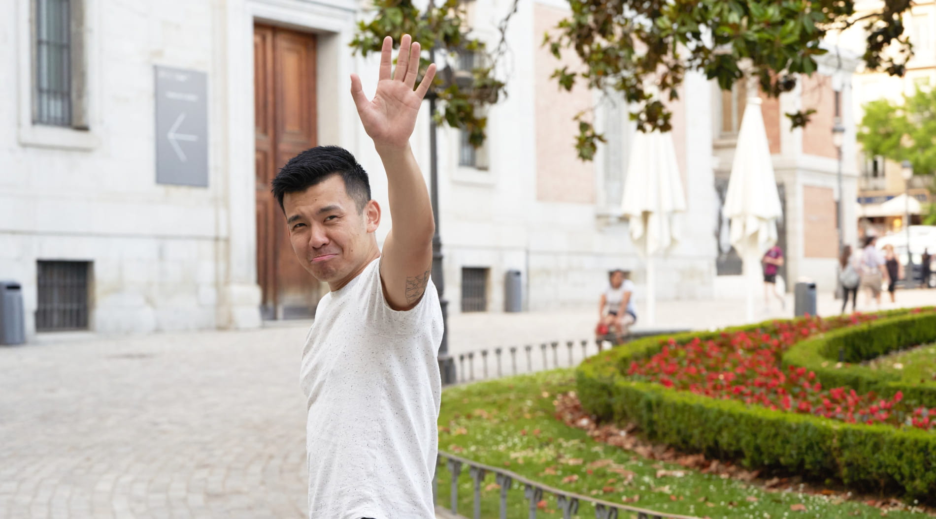Person waving goodbye outdoors